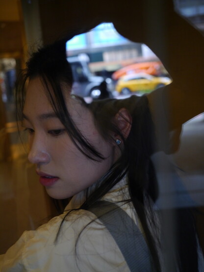 girl in revolving door with reflections