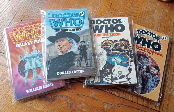 A small stack of Doctor Who paperbacks, including Galaxy Four, The Gunfighters, The Zarbi and The Talons of Weng-Chiang