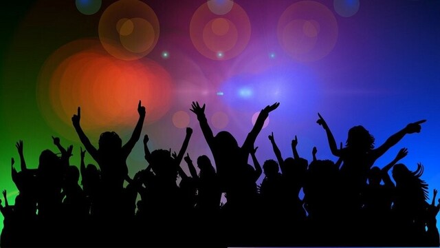 Silhouette of people dancing at a party.