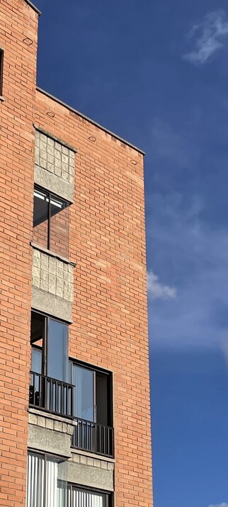 A corner of a building. The idea is to show the contrast of a bright orange brick colour against the bright blue colour of a clear sky.

Also, some light reflections on the windows help with the contrast.