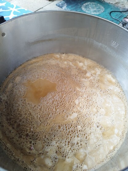 A foaming beer kettle about to boil