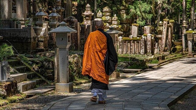 A Buddhist monastic walking through a monastery or temple.