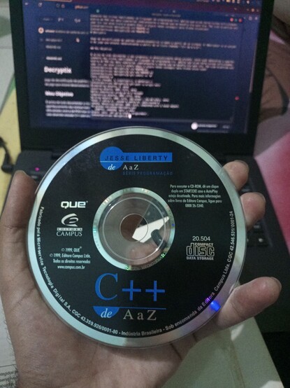 A old CD ROM with the game "decriptyx" and a Dev-C++ compiler