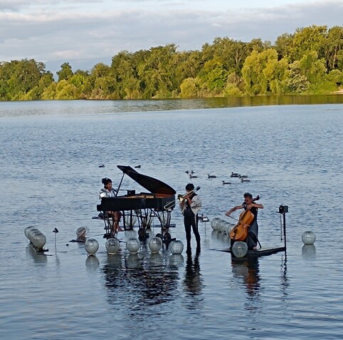 Music concert of a piano, trombone and cello on a floating platform on río Miño.