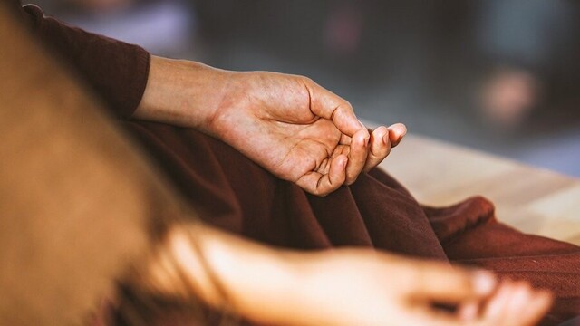 Closeup of hands of Buddhist monastic.