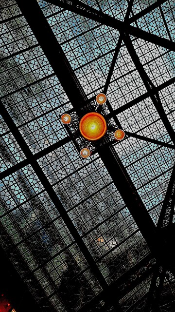 The atrium ceiling in "The Rookery" building, a lattice of glass and steel designed by Frank Lloyd Wright.