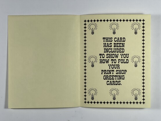 The inside of the folded greeting card that reads “This card has been included to show you how to fold your print shop greeting cards.” It has a diamond border with cartoon lightbulbs inside. 