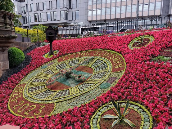 Beautiful and huge floral clock with many, many flowers in bloom. 