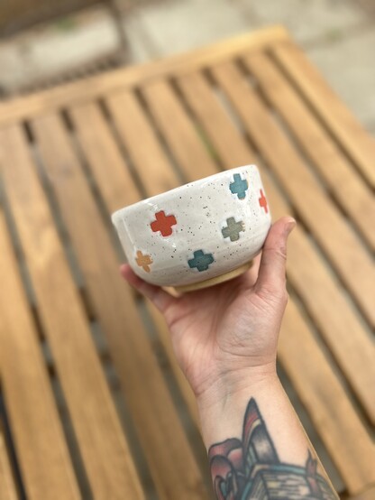 handmade pots decorated with colorful underglaze plus signs 