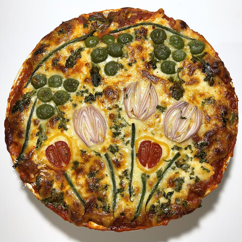 Overhead view of the gardenscape lasagne, straight out of the oven. The cheese is bubbly-brown and the flowers can still be detected after baking. 