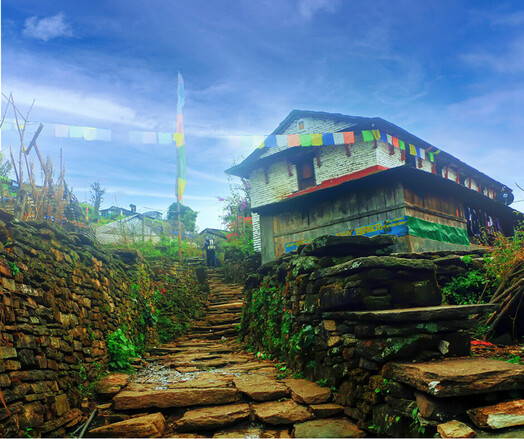 Prayer flags are displayed at a traditional house in Ghandruk village.