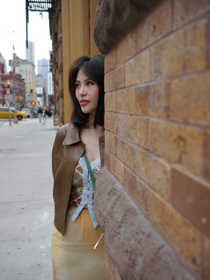 Girl against brick wall 