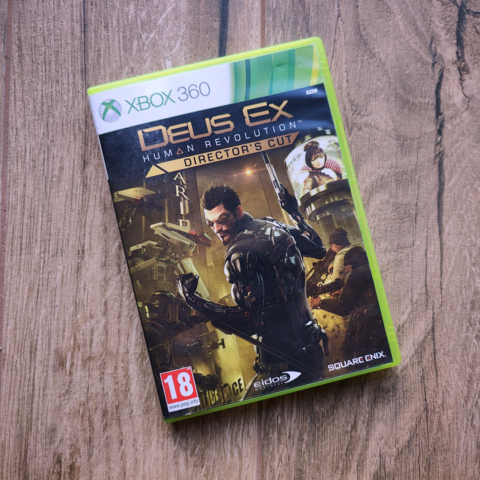 Pudełko gry DeusEx Human Revolution Director's Cut na konsole Xbox 360.