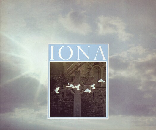The front cover of Iona by John G. Dunbar and Ian Fisher, published by HMSO for the RCAHMS in 1988. The background is a full cover colour photo of the sun breaking through a cloudy sky and at the centre is the title in white on pale blue above a colour photo of the replica of St John's Cross, surrounded by white doves in flight, in front of the Benedictine Abbey originally founded by St Columba in 563AD.