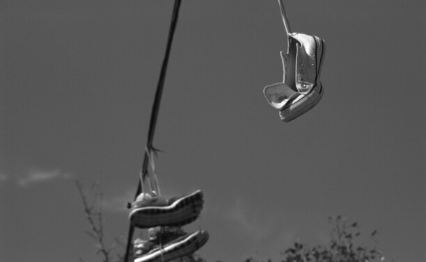 Shoes hanging from a utility line.