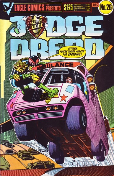 The front cover of Judge Dredd 1:26 from December 1985, featuring a full cover colour illustration by Brian Bolland of Joe Dredd busting his chops through the windscreen of a speeding ambulance.