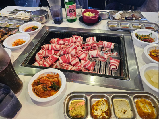 Another picture of meat on the grill, very thin slices of beef