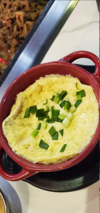picture of a small bowl of scrambled eggs, that are steamed with what i believe was chicken stock