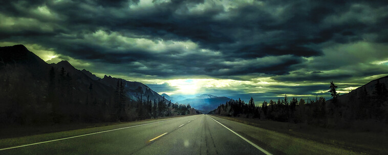 On the highway heading to Jasper Alberta under very dark cloudy skies.
