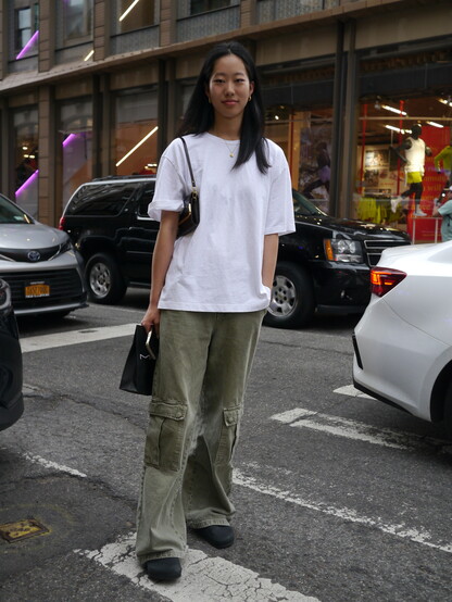 girl in white tee shirt and green pants
