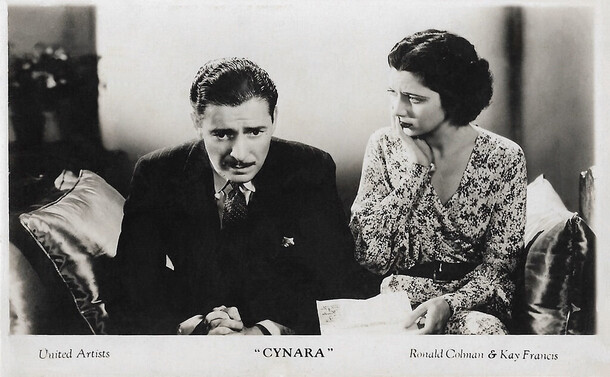 Ronald Colman and Kay Francis sitting together on a sofa in the 1932 pre code romantic drama “Cynara”