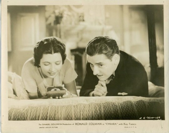 Ronald Colman and Kay Francis laying on a bed in the 1932 pre code romantic drama “Cynara”