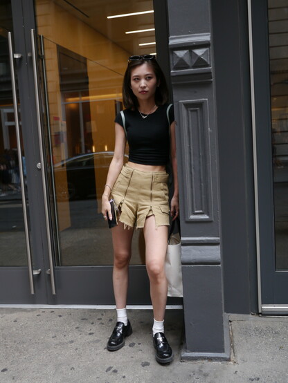 girl leaning against store front