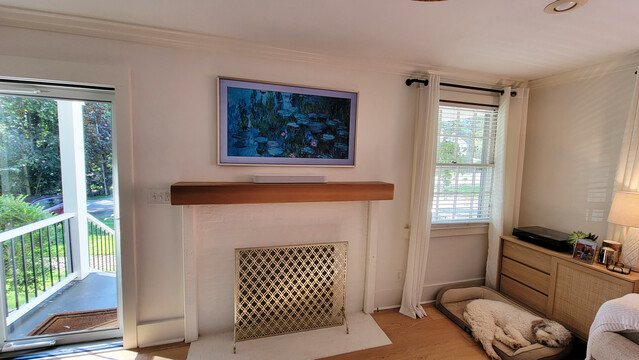Picture of a Frame TV and Sonos soundbar that we installed. Samsung Connect box and a Apple TV sits in a custom panel box installed behind the TV. Custom panel is wired with a surge protected electrical outlet.