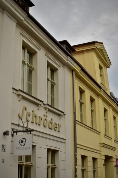 Storefront of plaster faux stone with molded nameplate “Schröder”