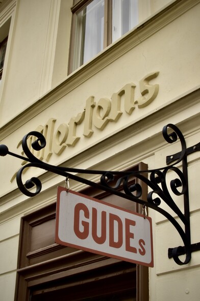 Molded plaster lettering “Mertens” with hanging sign “GUDEs”