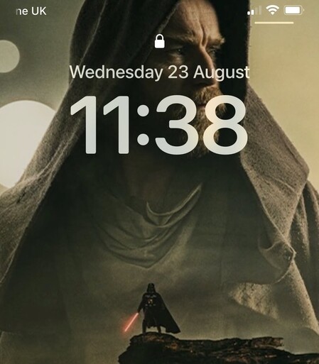 Time of 11.38pm displayed on phone screen with Kenobi background image.
