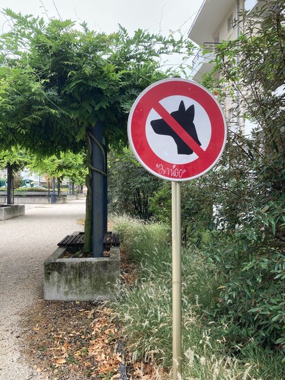 A sign banning dogs from a square, across the border in France. 