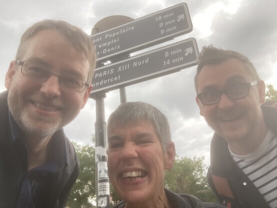 A selfie of Rohan, Annalu and Tom in front of a sign in Paris. 