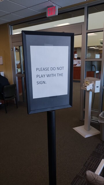 photo of a sign that reads "please do not play with this sign"