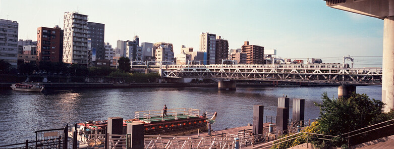 Sumida River in Tokyo with the train crossing the river on a sunny summer afternoon. Kodak Ektar 100 with Fujifilm TX-1. 