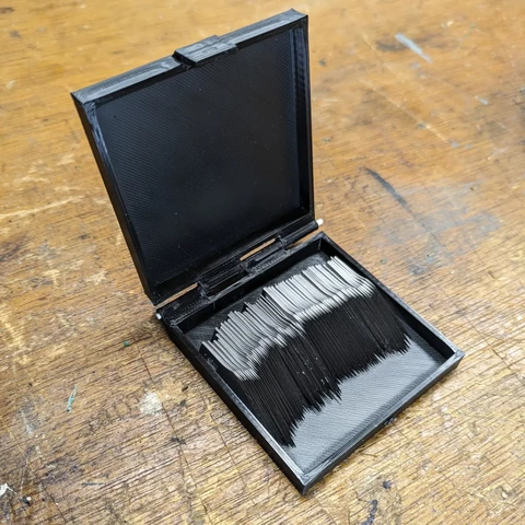 Small box shown open and containing hobby knife blade refills.