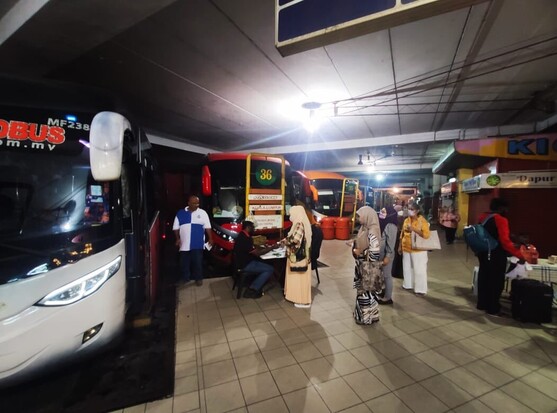 Bus passengers queuing to board an express bus.