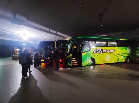 Passengers queuing to board an express bus.