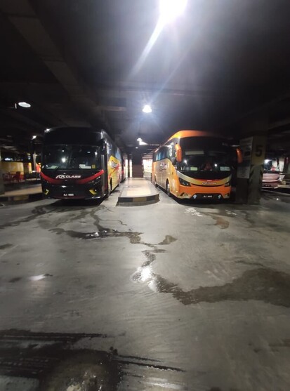 Two express bus at a bus terminal.