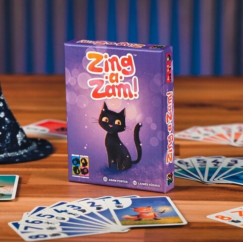Box cover of a board game Zing-a-Zam: purple background with a cute black cat.