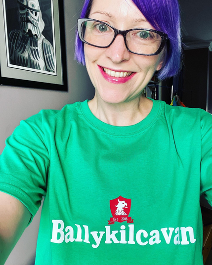 Pale white lady in green Ballykilcavan shirt