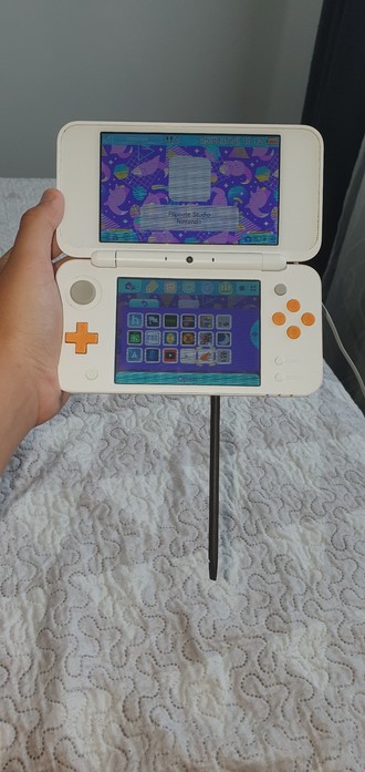 An inage of a repair tool from Ifixit stuck into the stylus port on my 2ds xl