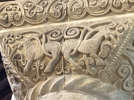 12th century carving in St Peter’s church Northampton two horse like beasts with curling botanical elements