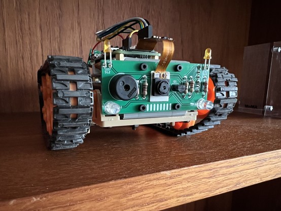 A small remote-controlled rover with a custom pcb front plate