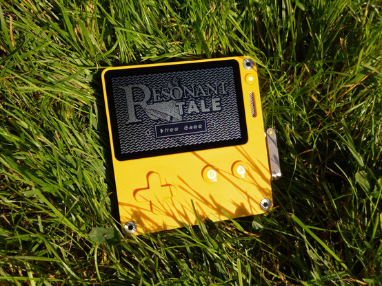 Photo of a Playdate lying in some grass. The Resonant Tale title screen is displayed with "New Game" selected.