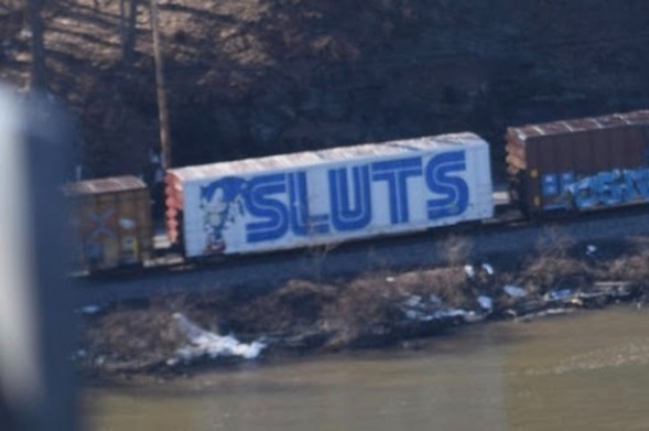 Train car with the word "sluts" on the side. 