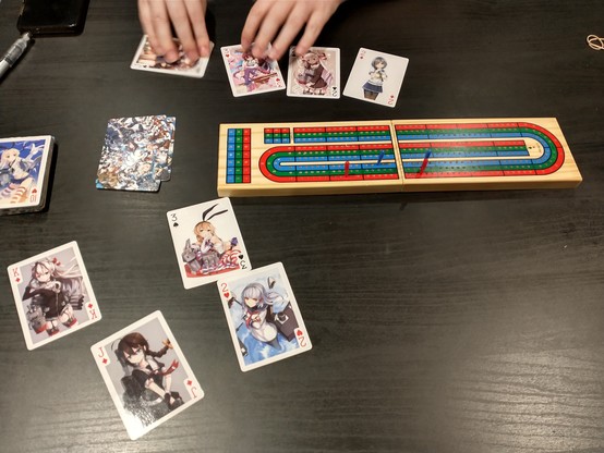 Game of cribbage with a deck of cards absolutely chockablock with anime waifus
