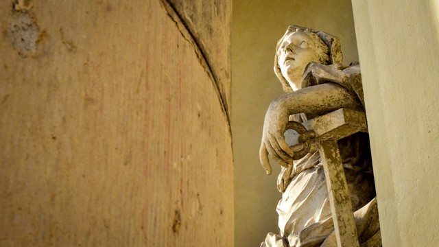 View of female marble neoclassical statue viewed from between stone columns, French Reformed Church (Huguenots), Potsdam, Germany