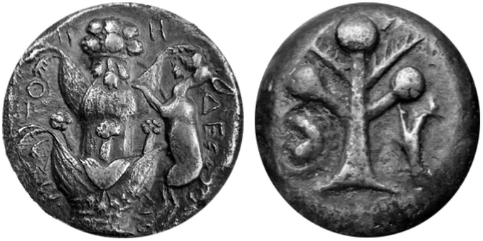 Photo of an ancient coin, showing both sides - one adorned with the image of a flower-like plant surrounded by various animals.