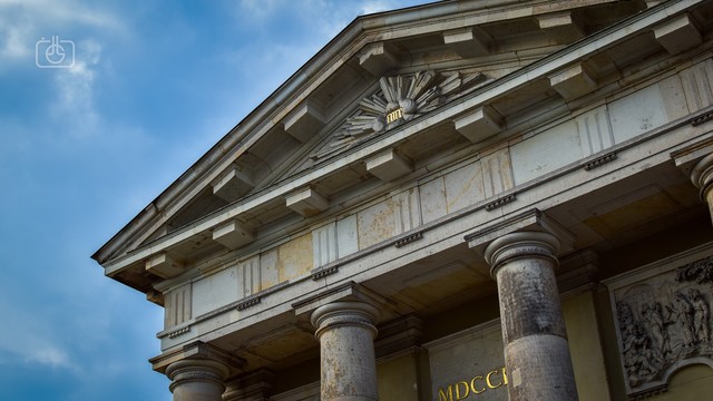 Neoclassical stone portico of French Reformed Church in Potsdam. Shows date of building in Roman numerals (MDCCLII, 1752) and inset tetragrammaton יהוה‎ in Hebrew (YHWH, the Name of God from the Torah, source of the renderings Yahweh and Jehovah, believed to mean “I am who I am”)
